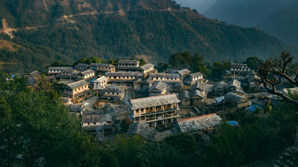 Captivating aerial view of traditional Ghandruk village amidst lush mountains in Nepal.